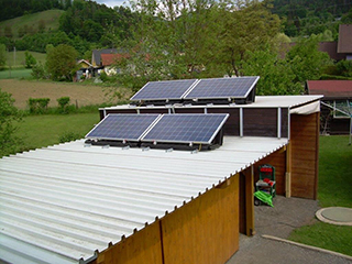 solar pac 1000 Flachdach in zwei Reihen übereinander auf einem Geräteschuppen im Garten.